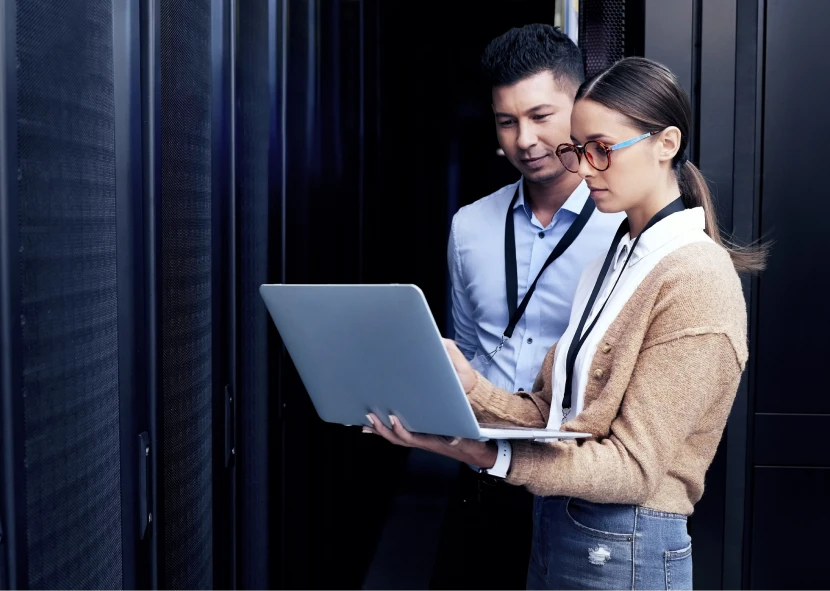 IT professionals working on a laptop.
